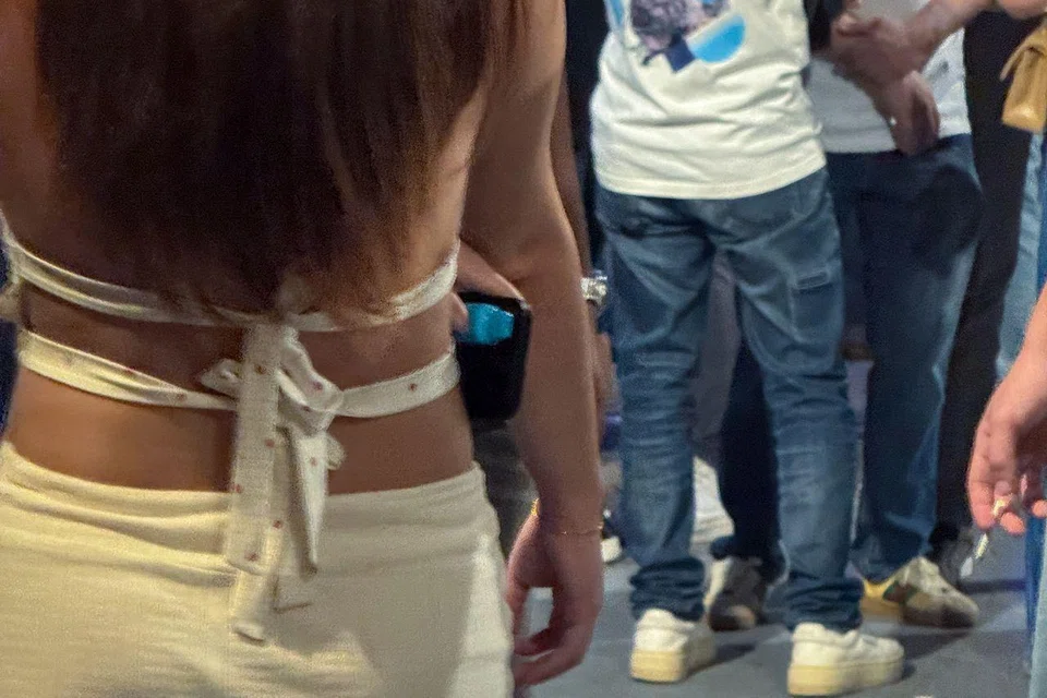 A woman with a vape at a smoking corner outside Zouk on Aug 23.