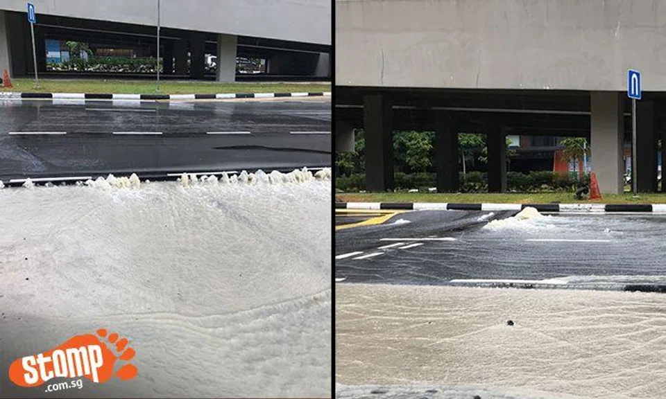 Muddy water gushing out of cracks on road opposite Ten Mile Junction LRT Station turns area into pool