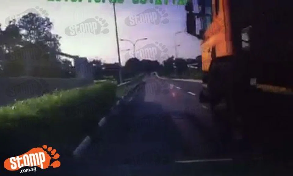 Woman driven into a corner by trailer truck on Tampines Expressway ...