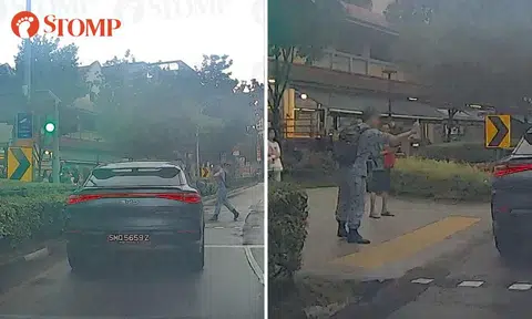 Man in military uniform points middle finger at driver after crossing on red in Hougang