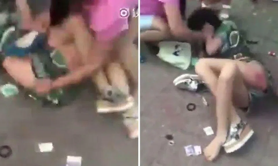 Women in China viciously hits, slaps and attempts to strip alleged mistress as she lies on the ground crying
