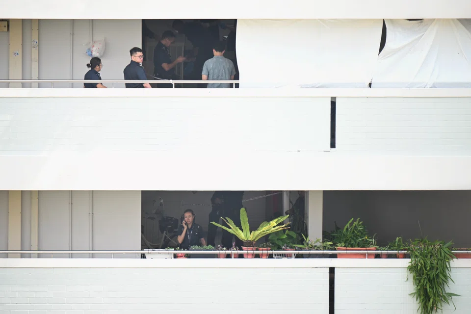 Police officers at Block 323 Yishun Central after the fatal knife attack on Sept 24.