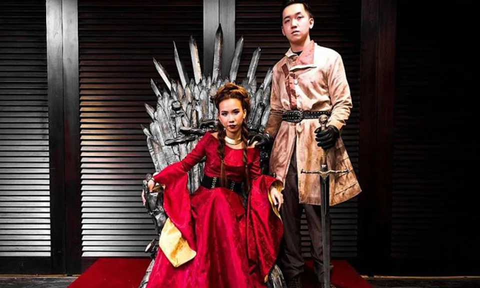 Ms Charlotte Lun and Mr Derek Lee on the Iron Throne replica they constructed. PHOTO: KC OF FLEUR D'SIGN