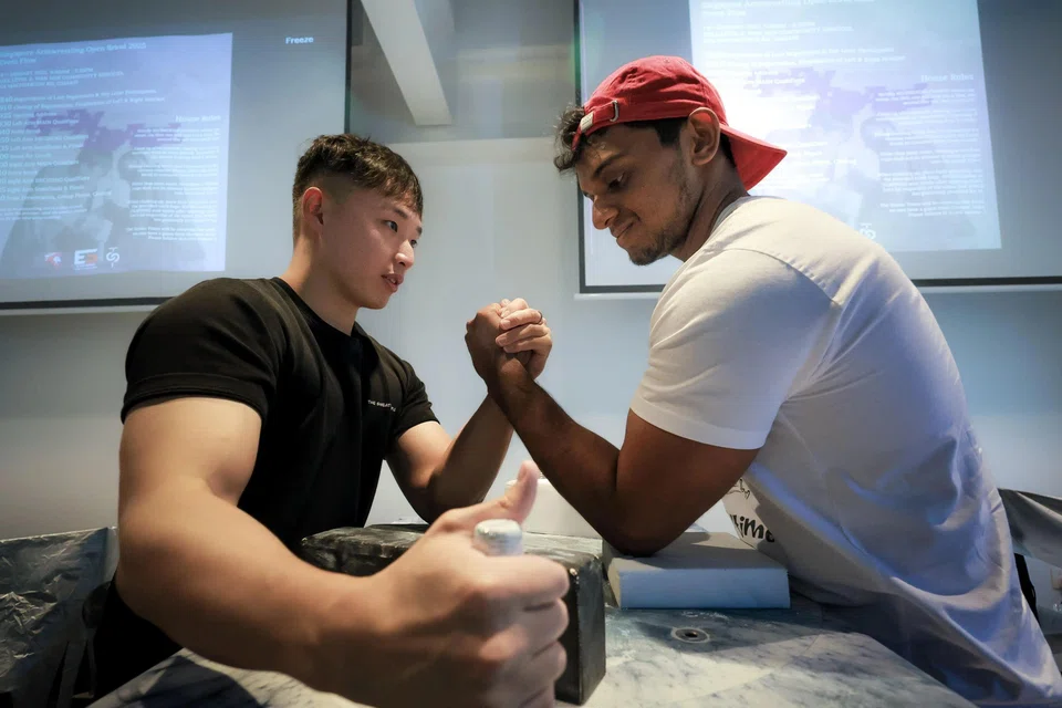 Singapore Armwrestling president Jasper Chan (left) posing with Thunga Niyanth from India at the Singapore Armwrestling Open Brawl in January.