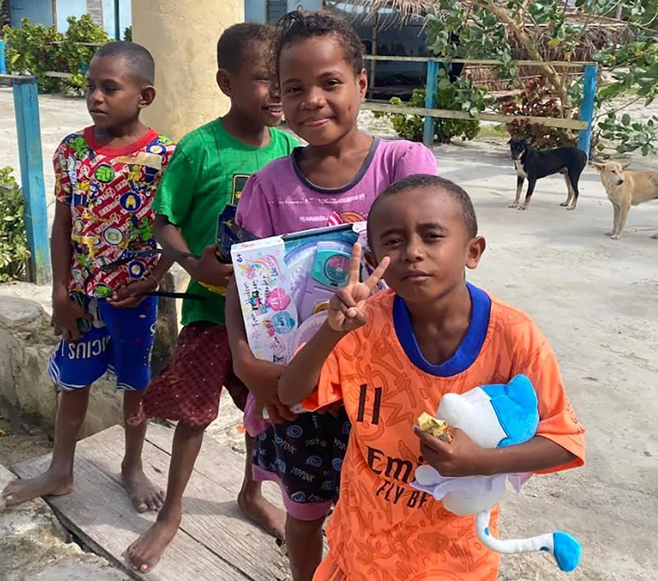 Indonesian children enjoying the toys donated by the Tan family.