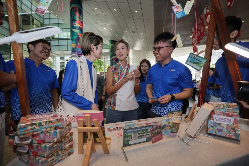 Minister for Digital Development and Information Josephine Teo (centre) visiting an exhibition booth at the NLB30: A Celebration Of Connections event at the National Library Building plaza on Sept 6.