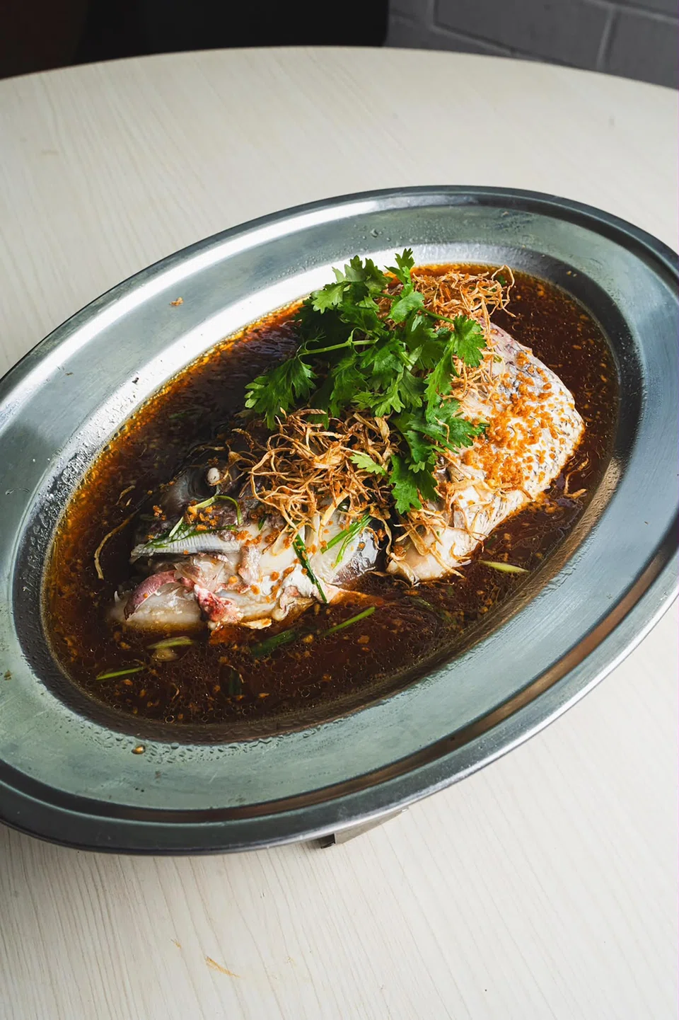 At $15, steamed fish head is the most expensive item on the menu at 20 Dishes Only.