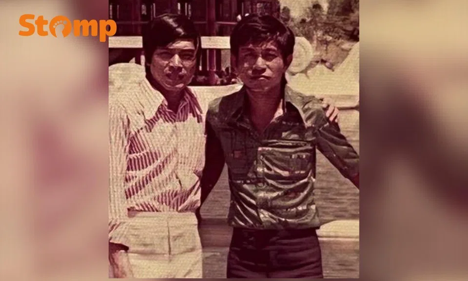 Two men in a sepia photo, with arms around each other.