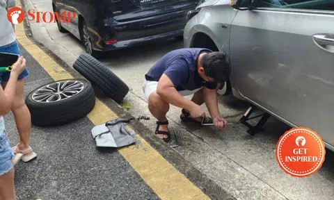 good samaritan stops to help woman change flat tyre at Holland Road