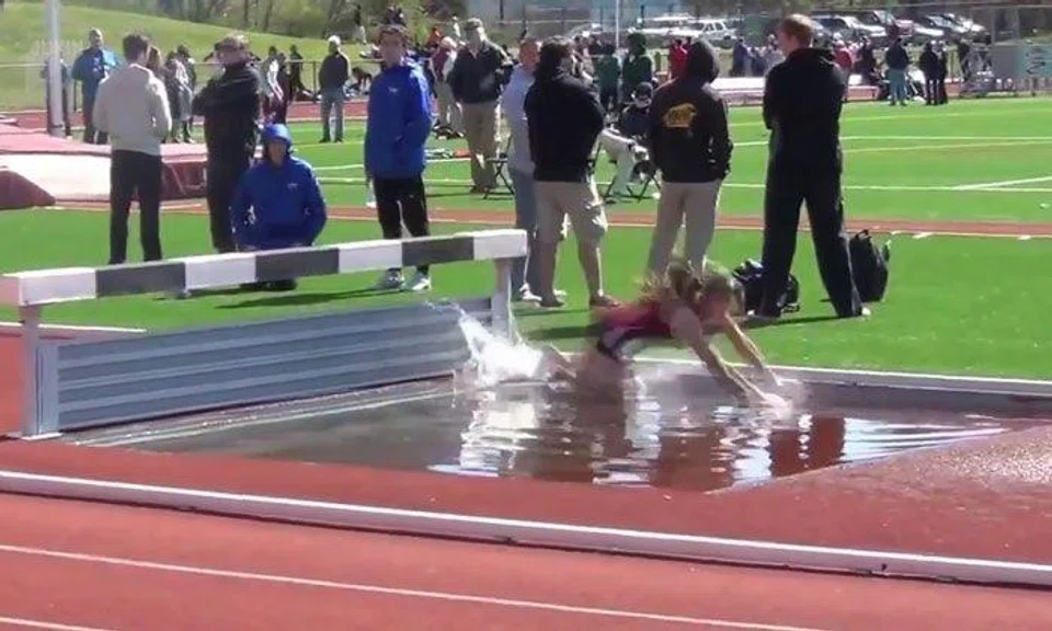Girl misses hurdle and falls into water during steeplechase -- but watch how she gets up like a champ