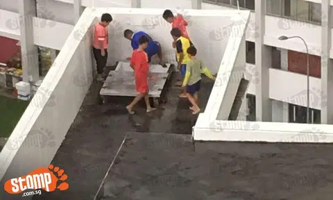 So what if it is raining? Kids dangerously climb up onto Blk 183 Yung Sheng Road carpark roof to play