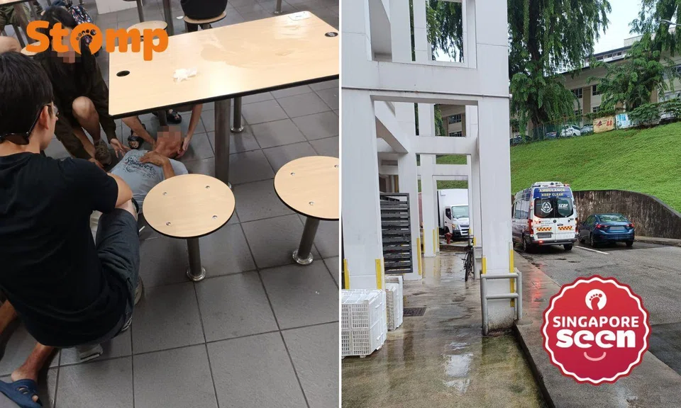 Man collapses under table, ambulance parks at the corner of the food centre.