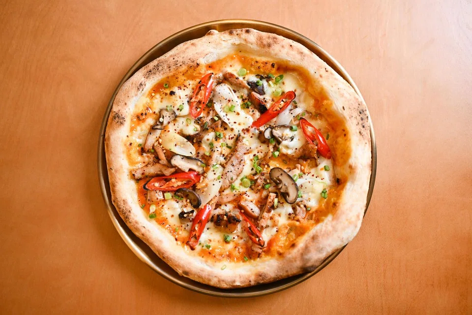 Korean Chicken Sourdough Pizza is made with a base sauce of gochujang blended with cream.