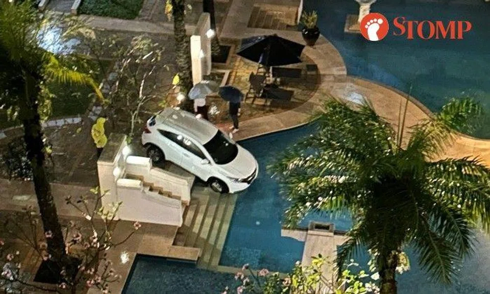 Sharing a photo of the car tilted over the edge of the pool with its two front tyres in the water, Stomper Kok said it happened at 10pm.
