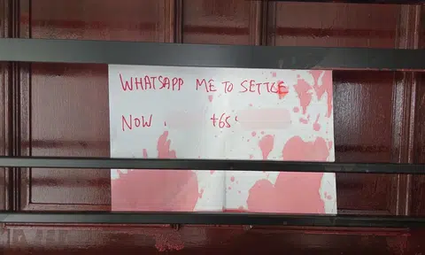 Canberra Road unit splashed with red paint, debtor's note placed on gate: Man arrested