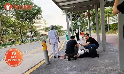 Good Samaritans aid woman lying on ground at Tampines bus stop, wait for ambulance with her