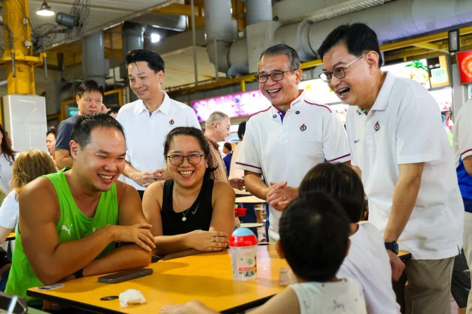 Deputy Prime Minister and East Coast GRC MP Heng Swee Keat (right) and Minister for Culture, Community and Youth Edwin Tong (second from right) on a walkabout at the food centre at Block 16 Bedok South Road on March 23.