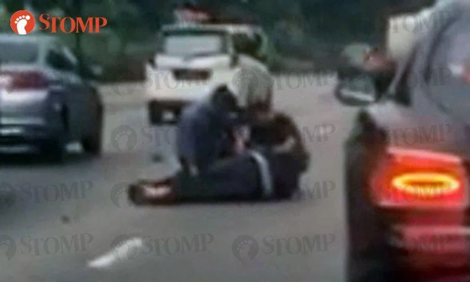 Accident victim lies motionless on SLE: Passing Police officers and motorists stop to help