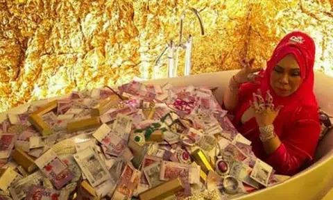 Malaysian beauty tycoon slammed for showing off obscene wealth by 'bathing' in money