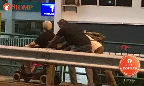 Kind-hearted passersby help push wheelchair-bound senior citizen up slope at Marsiling Drive