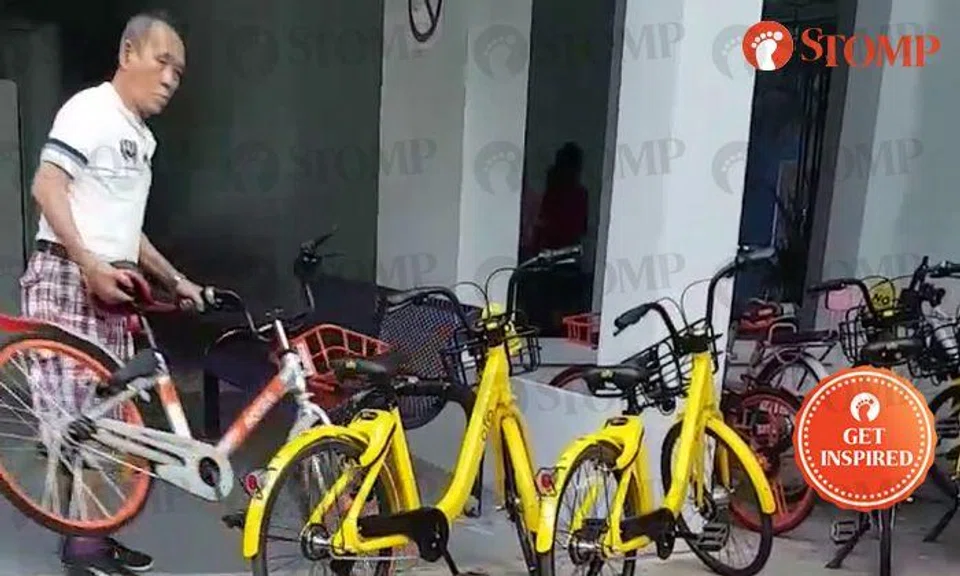 Uncle moving bicycles blocking walkway near Pioneer MRT Station is the hero we all need