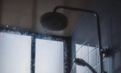 A photo illustration of a shower. The man placed a camera in the toilet, but the woman found it when it dropped as she took a bath. PHOTO: UNSPLASH