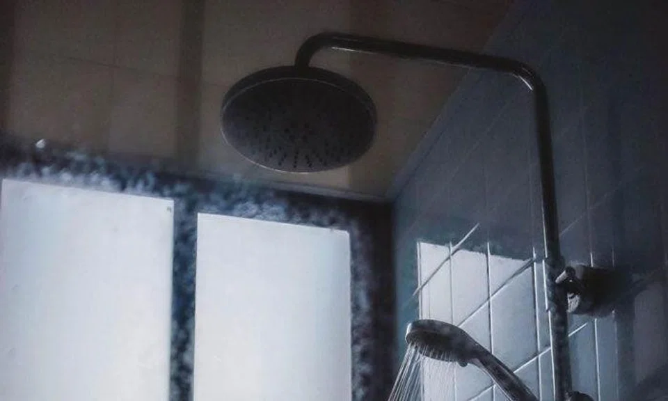 A photo illustration of a shower. The man placed a camera in the toilet, but the woman found it when it dropped as she took a bath. PHOTO: UNSPLASH