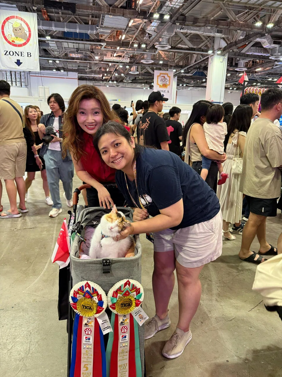 Ms Sheryl Woo (right) and Monkey with Ms Michelle Tay from Feline Club Singapore at The International Cat Association Cat Show.