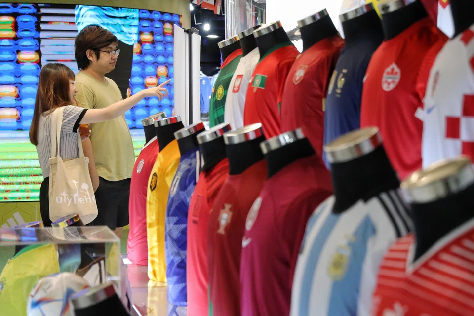 Customers browsing World Cup jerseys at Weston Corp’s store in Queensway Shopping Centre.