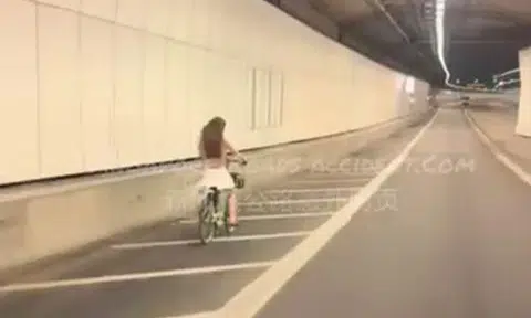 woman rides bike in kpe tunnel