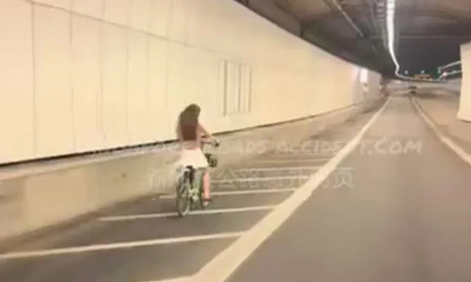 woman rides bike in kpe tunnel