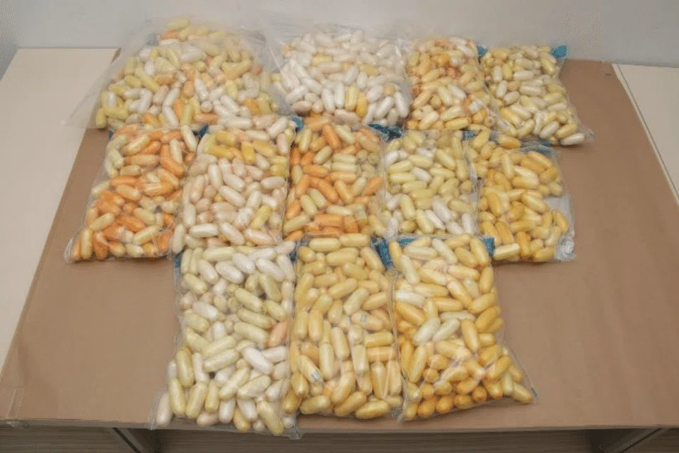 CNB officers found 26.9kg of cocaine and 10g of cannabis in the luggage belonging to two of the suspects.