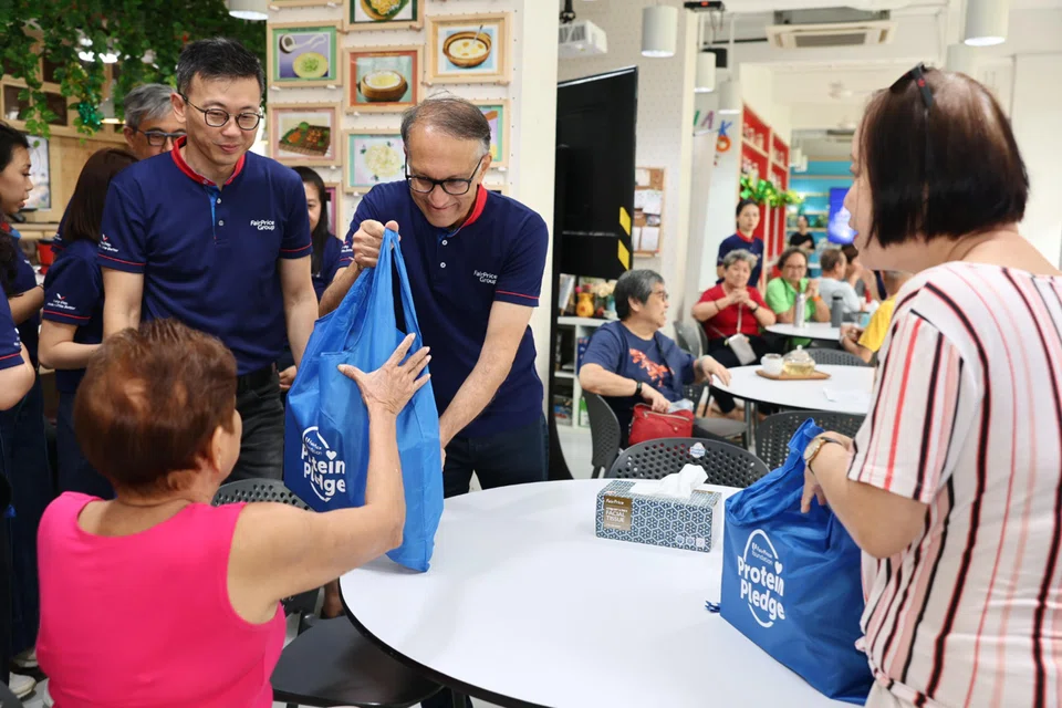 Mr Vipul Chawla, group chief executive of FairPrice Group, distributing care packs to senior residents on March 25.