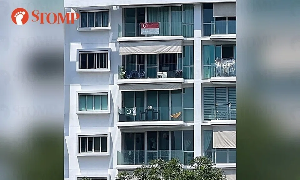 A Stomper shared a photo of the green-and-white flag two stories below a red-and-white Singapore displayed at the same building.