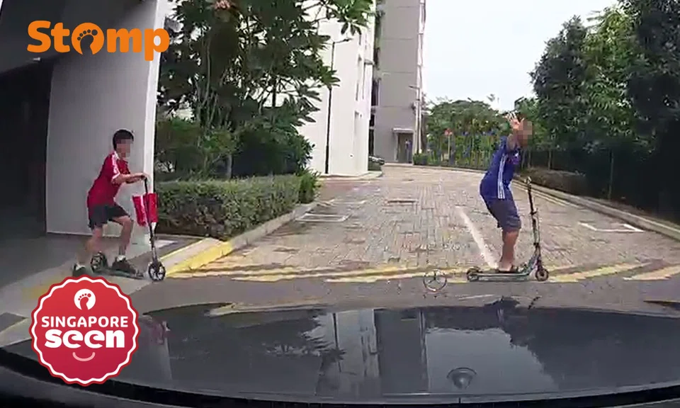 Driver shocked as 2 kids on scooters suddenly dash in front of him in Eunos