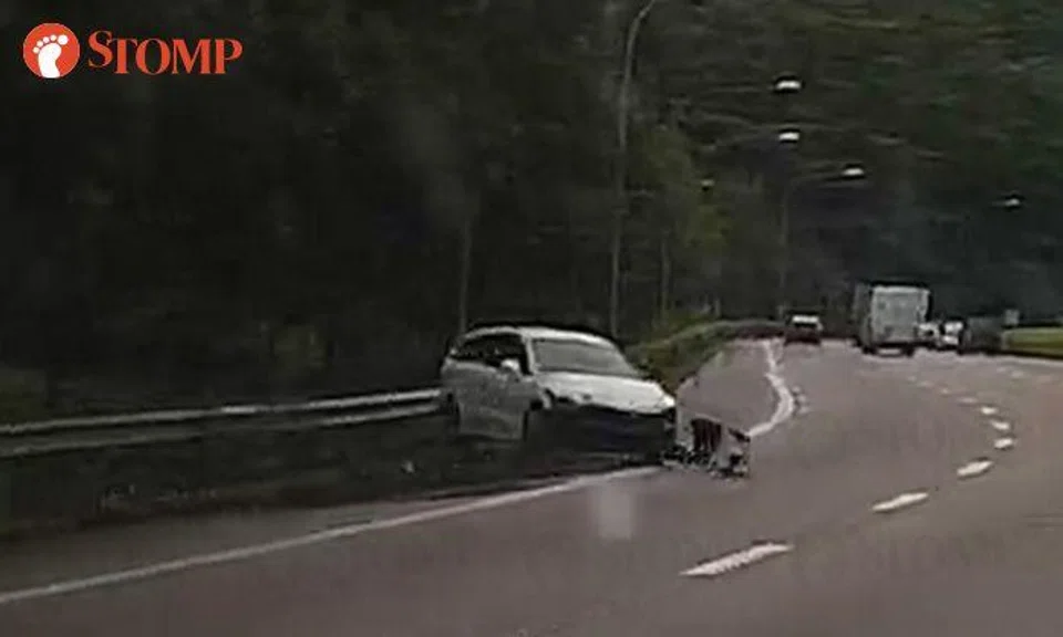 Car sent spinning after skidding and crashing into road barrier on PIE slip road