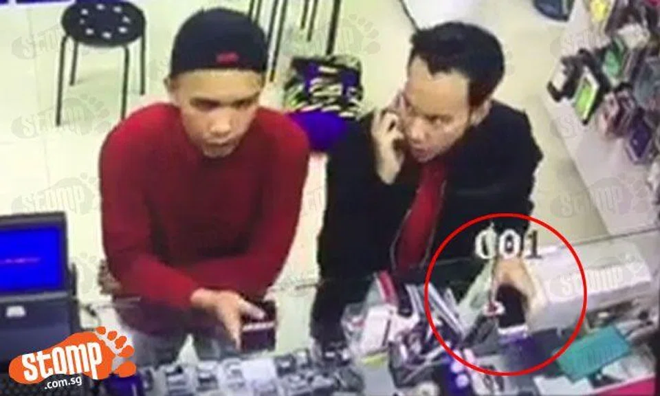 Man takes phone from shop while friend distracts staffer by asking for phone price