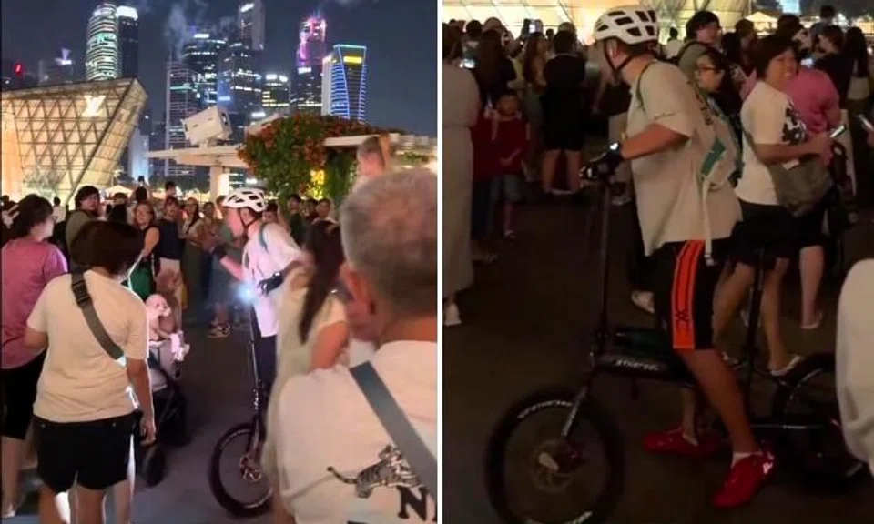 Cyclist yells at people in crowd outside MBS watching fireworks for not getting out of his way