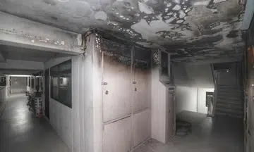 The walls and ceiling at the common corridor on the 10th floor of Block 501 Jelapang Road were blackened by smoke after the fire.