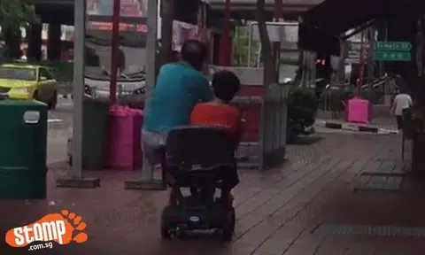 Isn't this dangerous? Uncle and auntie share a motorised wheelchair