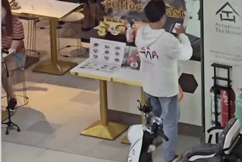 The man collecting his order at a stall.