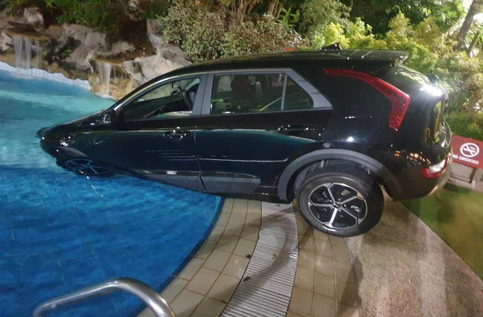 William Teng Guan How drove his car into the club's pool and then reversed out, before finally driving the front half of his car into the pool again.