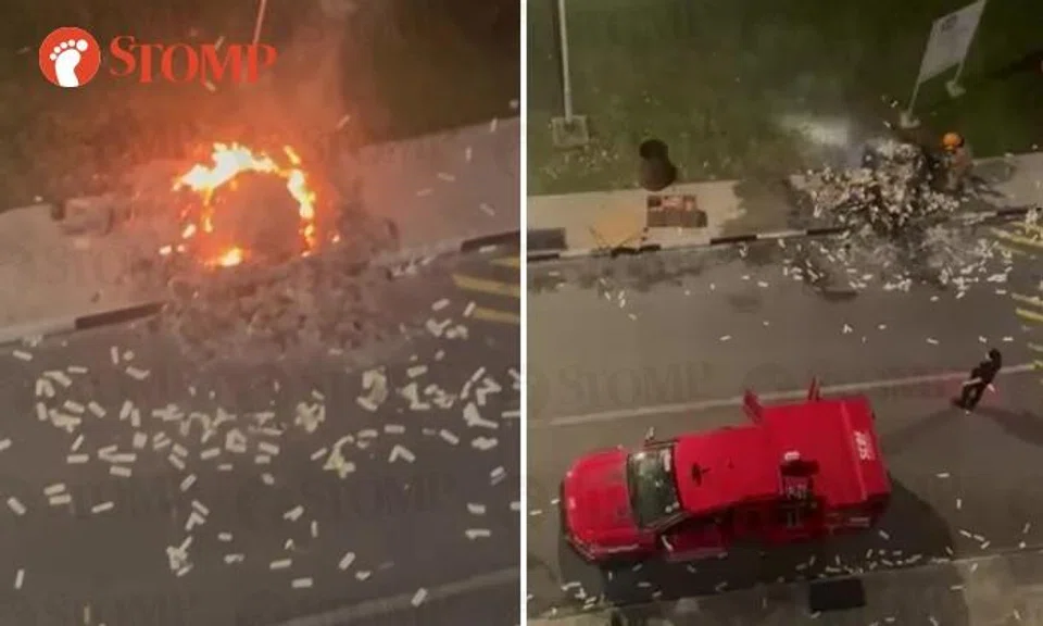 After the fire had burned itself out, an SCDF vehicle and firefighters can be seen under the block.