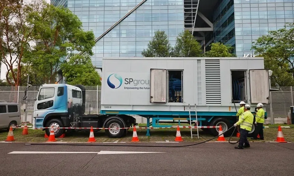 SP Group staff demonstrating how they set up a mobile power generator.