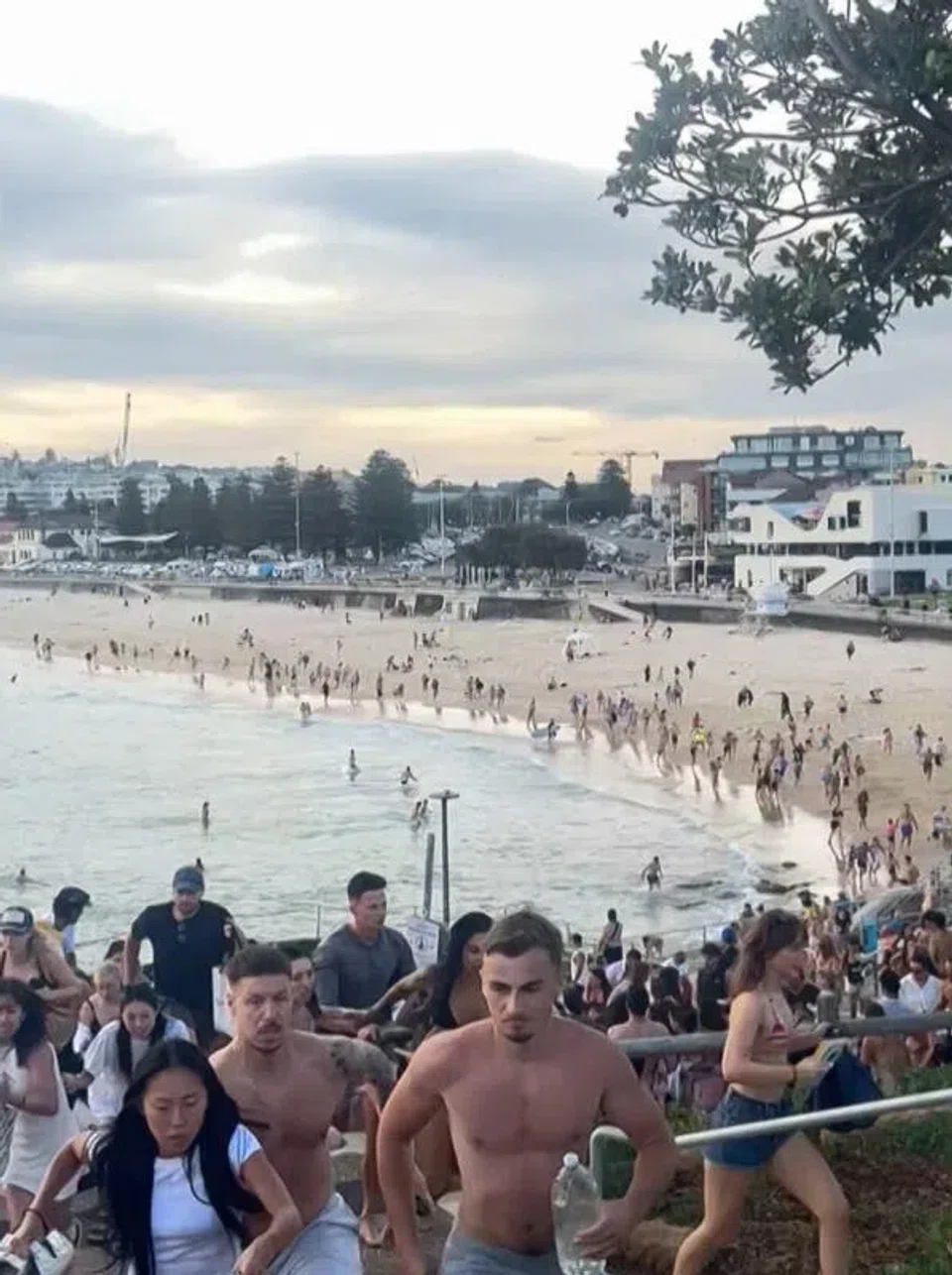 A screengrab from a video showing beachgoers fleeing Bondi Beach in Sydney after gunmen opened fire there on Dec 14. PHOTO: AFP