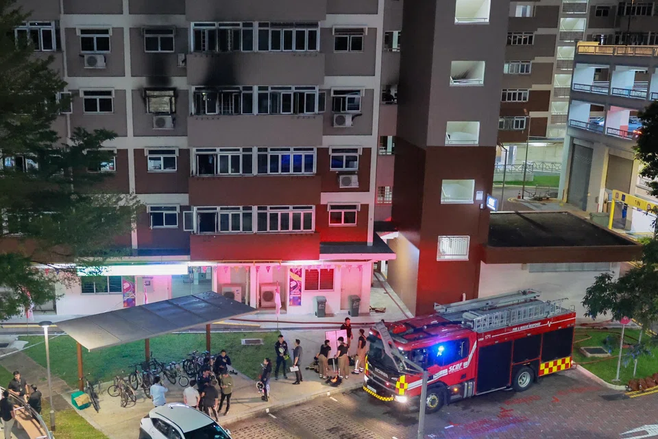 Residents at the ground floor at Block 106 Jalan Bukit Merah, where a fire occurred in a flat on the fourth floor on Aug 13.