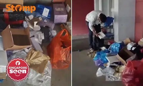 Men taking items from parcels left at Jurong block
