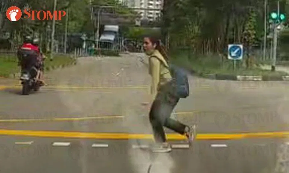 Woman nearly hit by traffic after dashing across road in Sengkang, shocks both herself and motorists