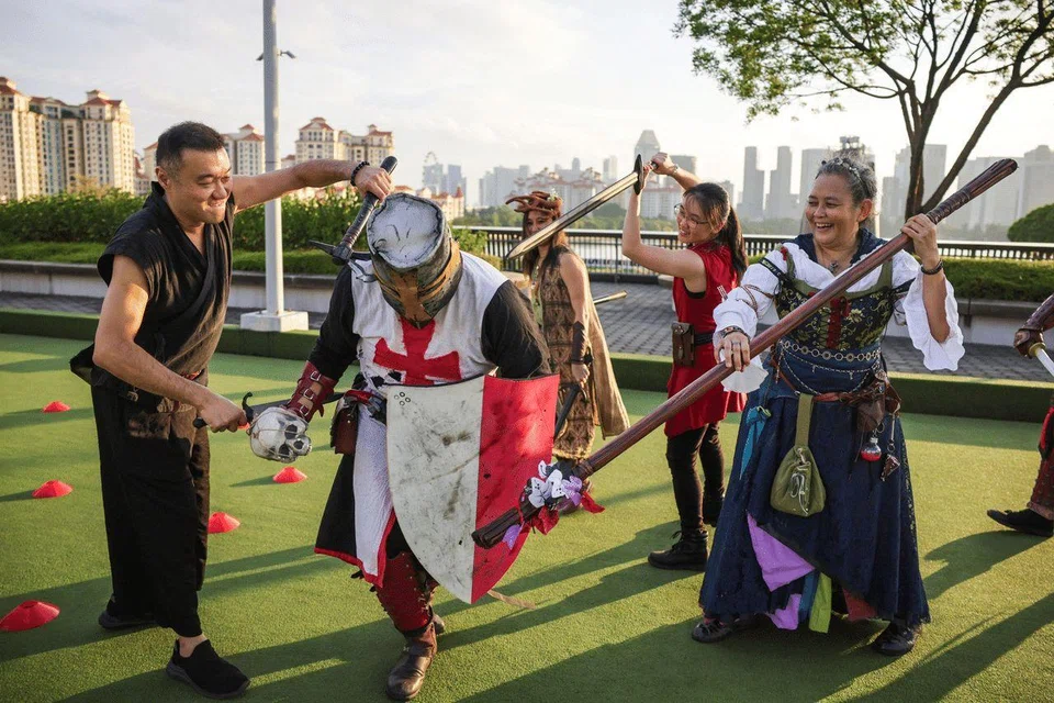 Members of Larp Singapore Community role-playing in their costumes at the Lawn Bowl in Singapore Sports Hub on Aug 16.