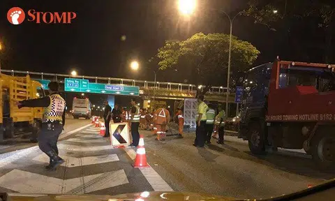 Driver taken to hospital after tipper truck overturns along PIE and spills pebbles on road